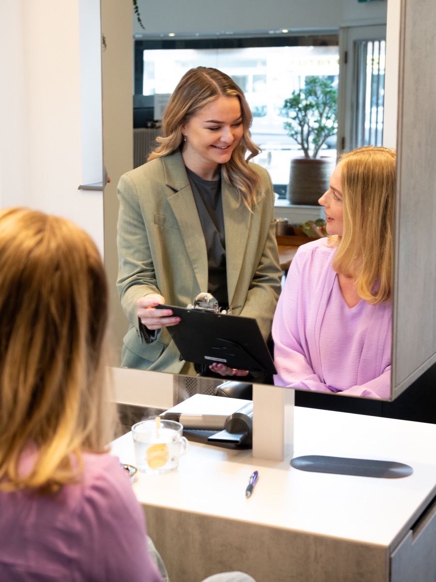 Stylist en klant voor de spiegel